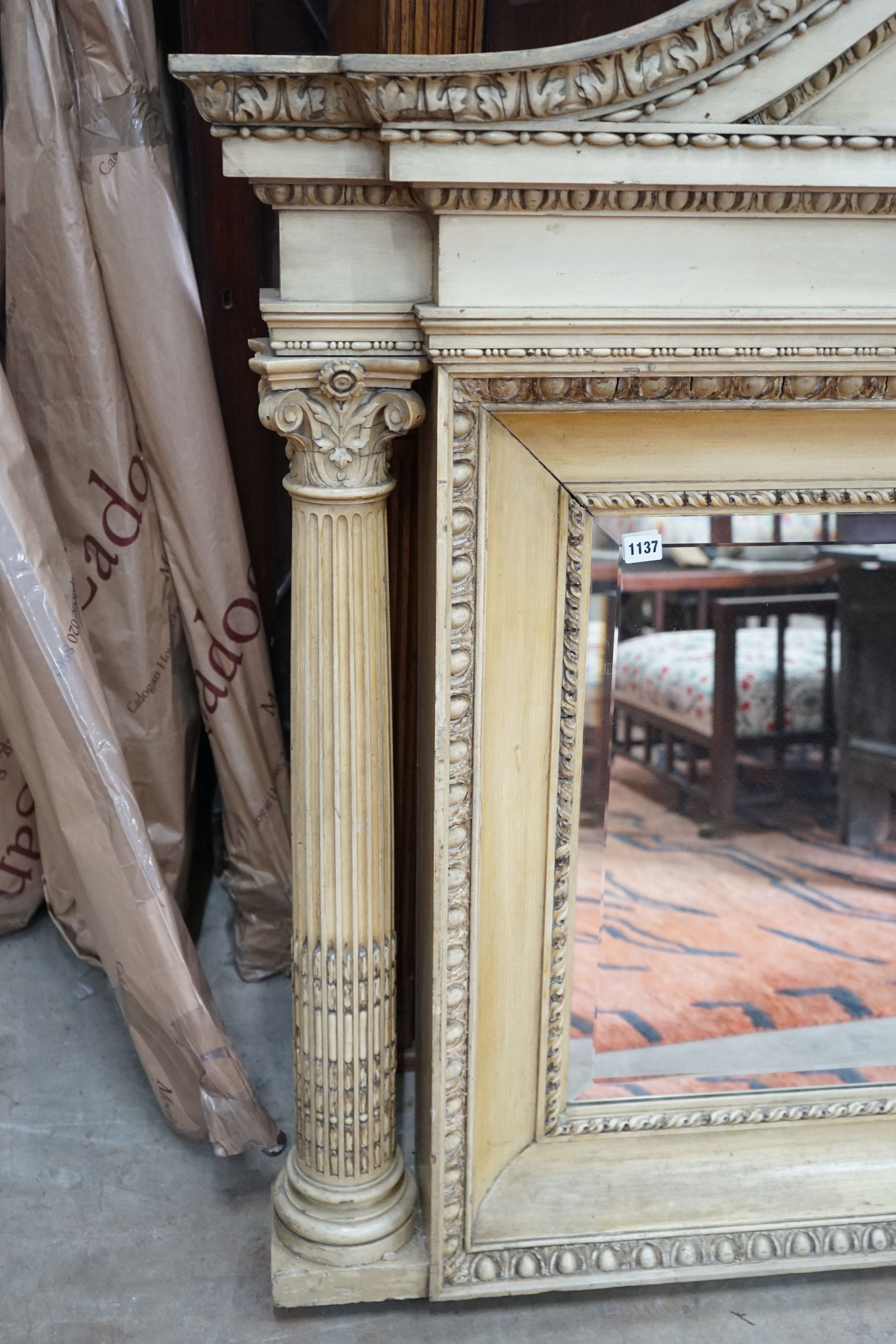 A George III style painted wood and gesso overmantel mirror with rectangular bevelled plate flanked by Corinthian columns, width 152cm, height 122cm